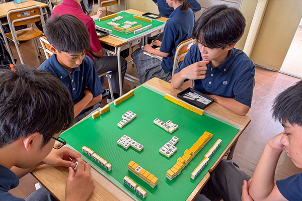「世界最高峰のブレインスポーツ Mahjong(マージャン)を覚えよう」で、卓を囲んで実践を楽しむ生徒たち